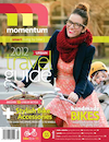Cover of an issue of Momentum magazine, showing a white woman and child on a bicycle.