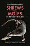 Book cover, showing a dark-coloured shrew swimming underwater to catch an aquatic invertebrate. The background is black and the shrew has tiny air bubbles in their fur.